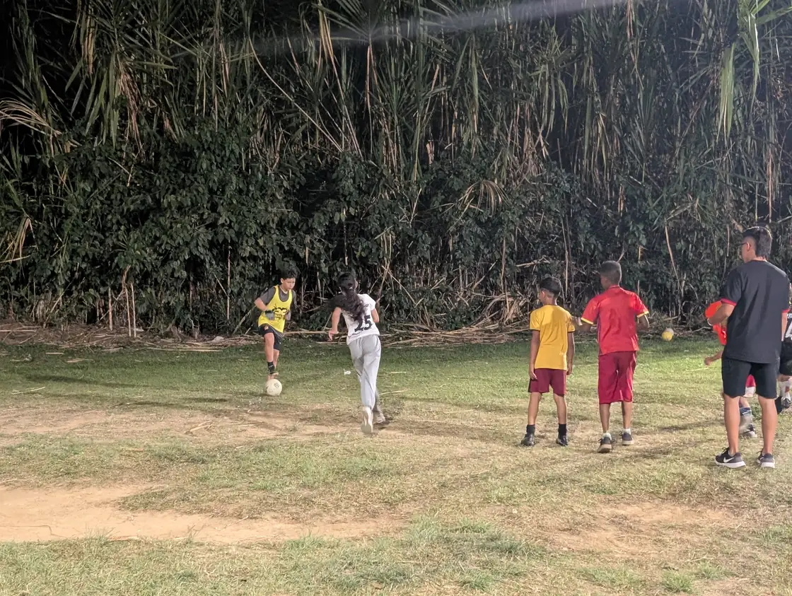 Alpha FC players practicing together on a field in Pereira