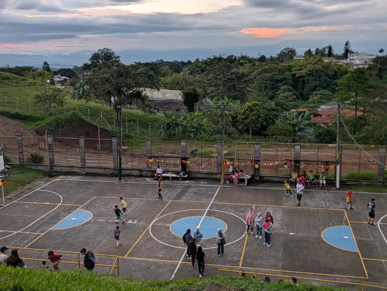 A wide view of an Alpha FC community court and the surrounding Pereira landscape