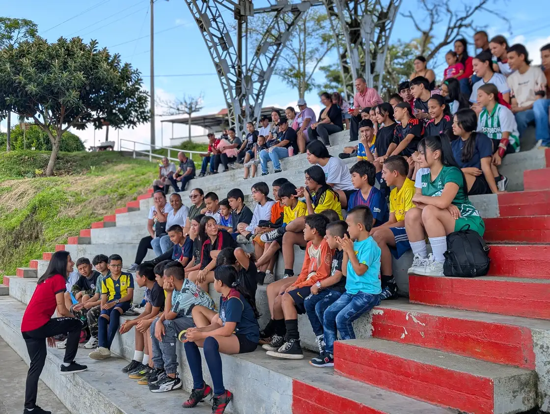 Alpha FC participants and families watching an event from the stands in Pereira