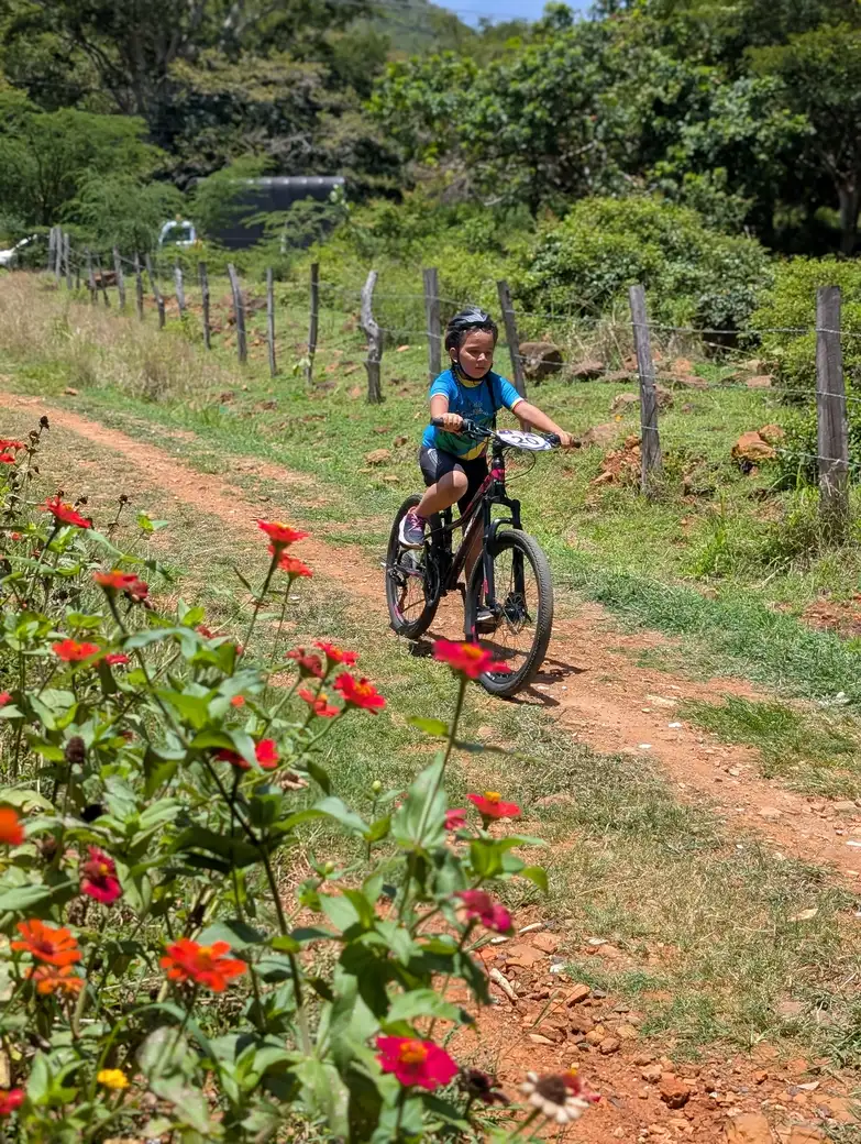 A Pedalea con Conciencia rider traveling along a rural trail near Cabrera